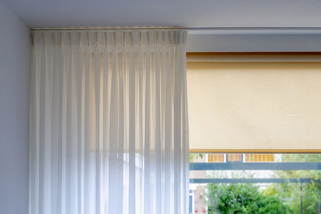 The many attractions of installing sheer curtains over roller blinds